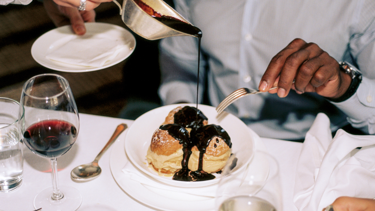 A waiter serving a dish