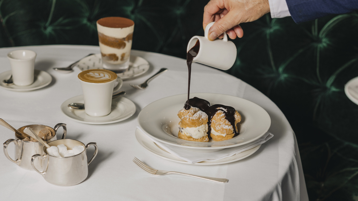 A waiter serving a dish