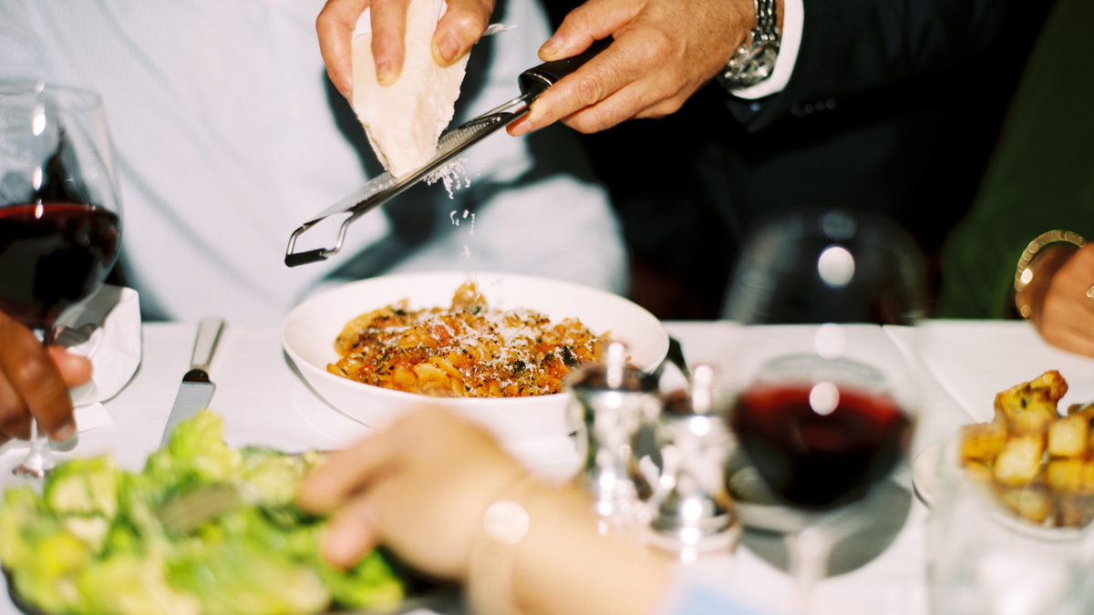 A waiter serving a dish