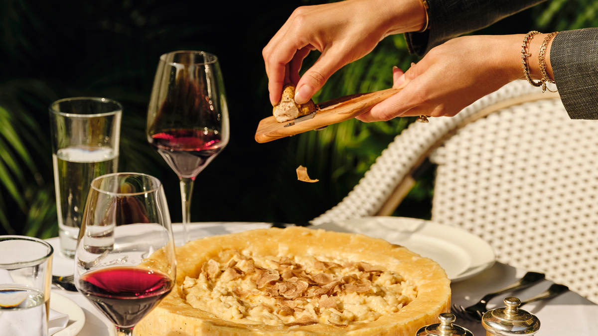A waiter serving a dish